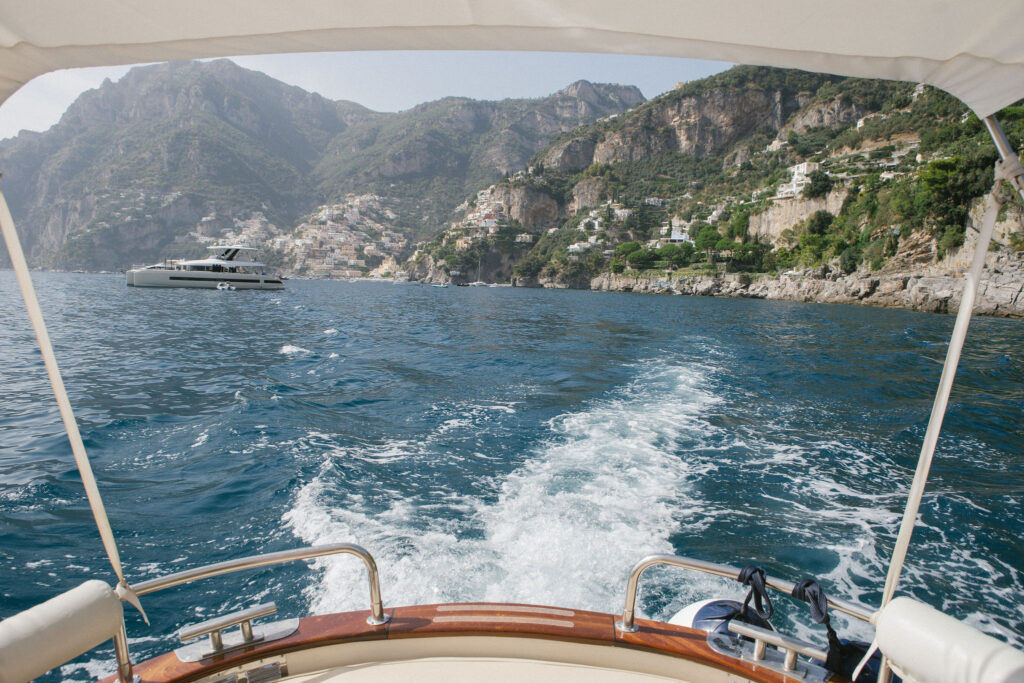 View from a romantic boat ride along the Amalfi Coast with Positano in the distance – the perfect setting for a surprise proposal