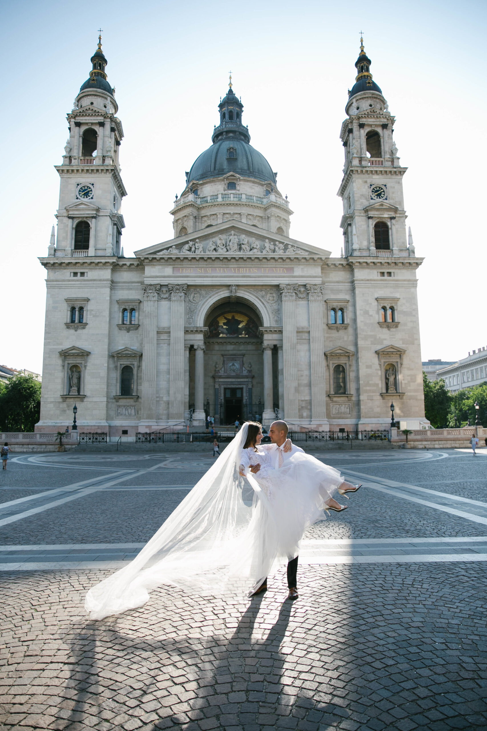 Bride and groom wedding portrait in front of St. Stephen’s Basilica in Budapest, captured by destination wedding photographer Helga Antal