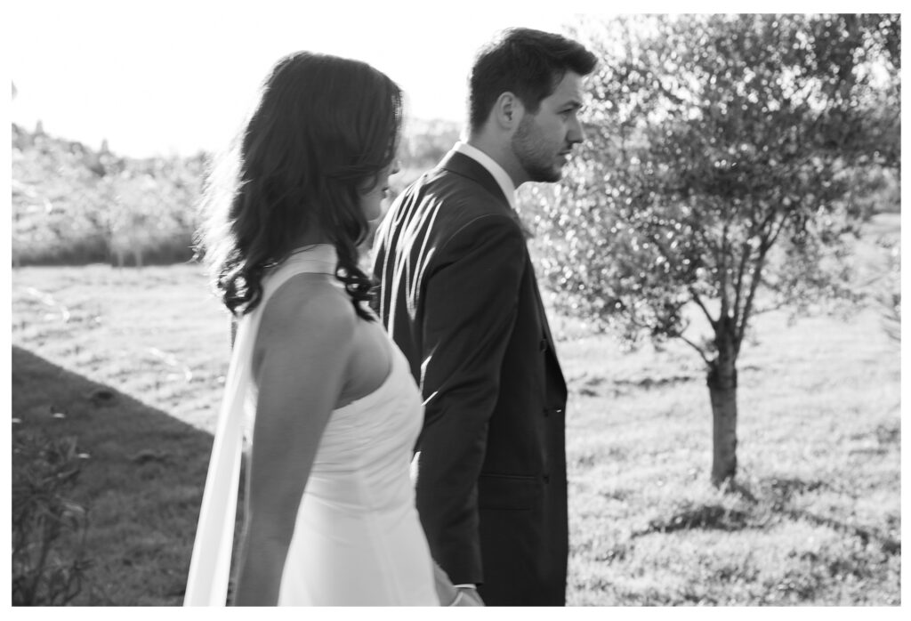 Bride and groom walking together during golden hour at Le Manoir de Lisle, captured by Toulouse wedding photographer.